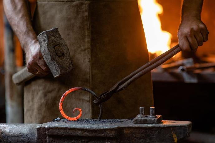 Artisanal blacksmith working with wrought iron